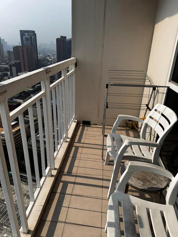 fully furnished 2-bedroom unit in Senta Makati with a balcony facing the park and Manila